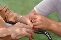 Picture of an elderly woman and younger woman holding hands
